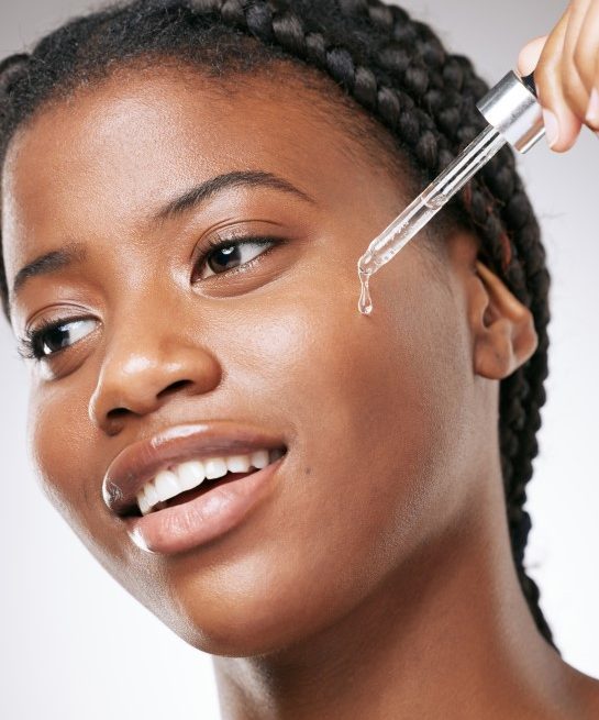 african-woman-with-amina-products-oil-dropper 545x750